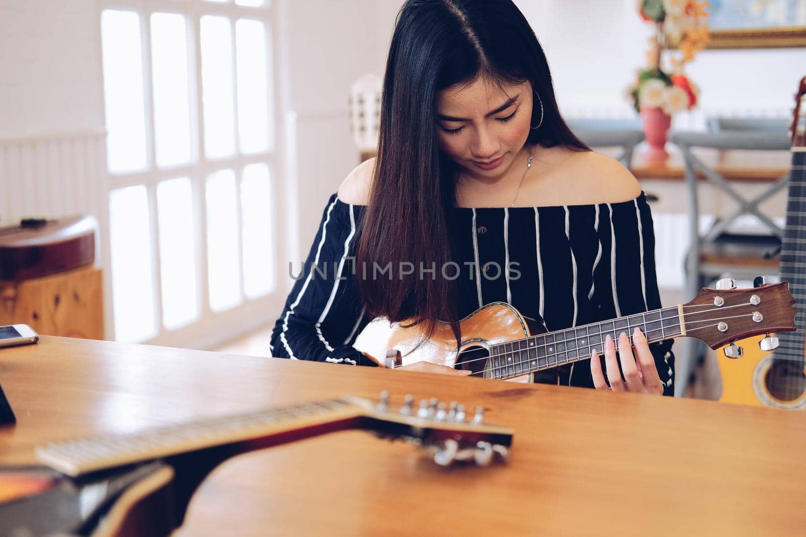 woman playing guitar at home.  leisure lifestyle concept