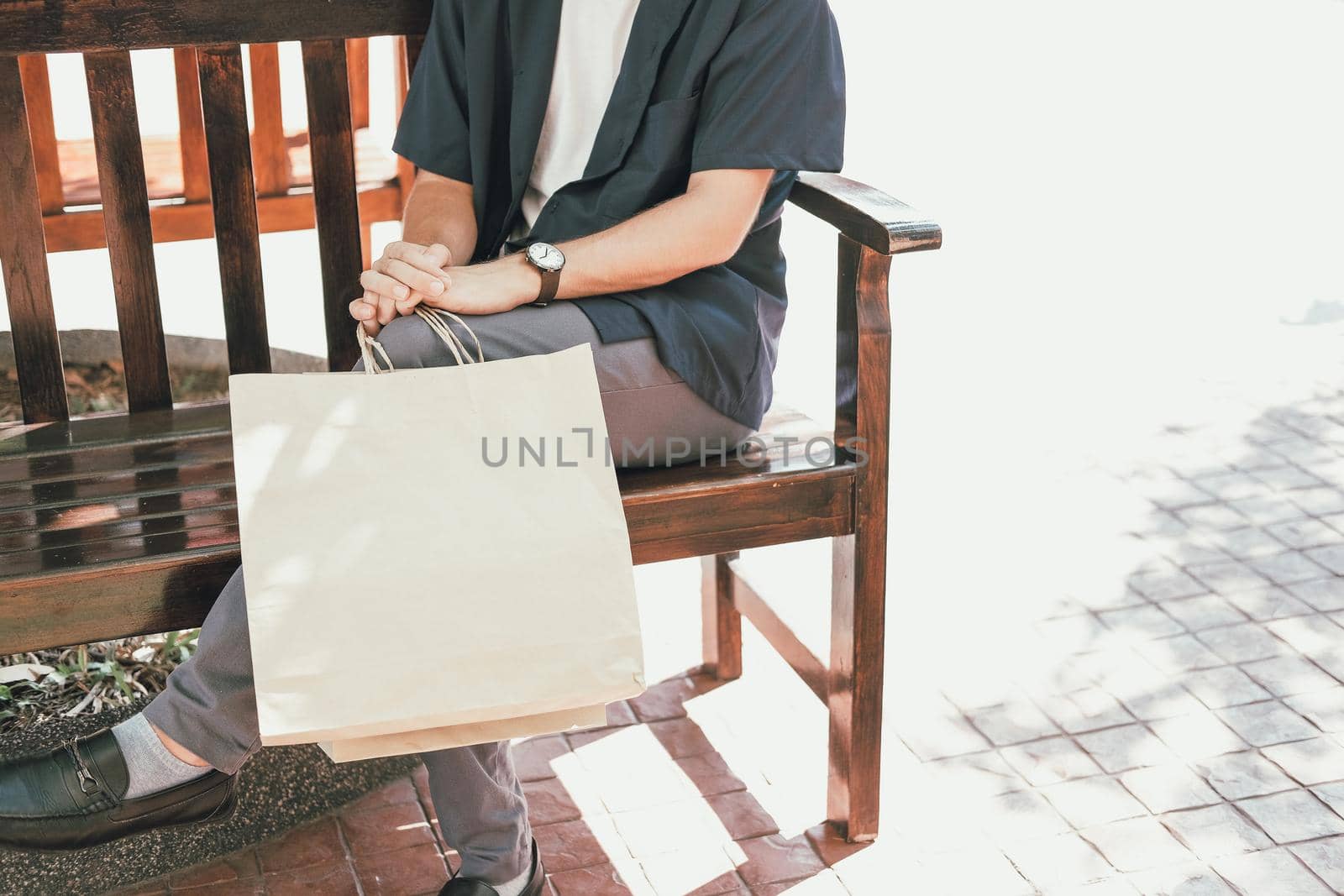 man sitting resting with shopping bags at shopping mall. consumerism lifestyle