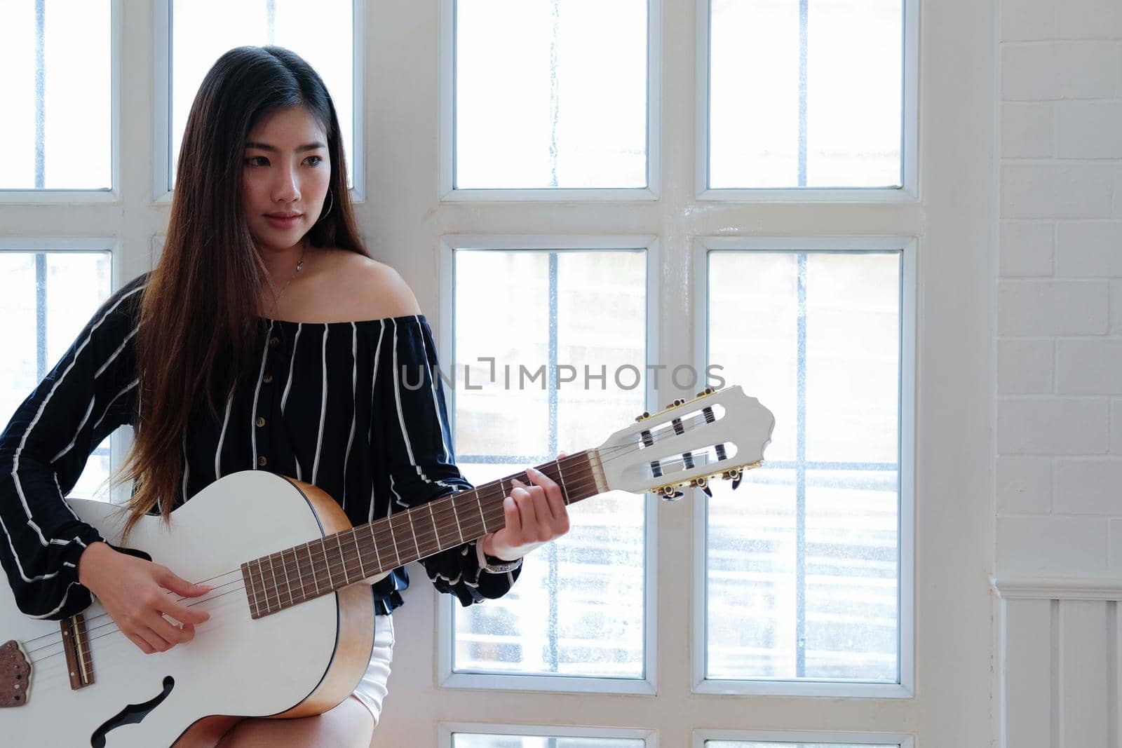 woman playing guitar at home.  leisure lifestyle concept