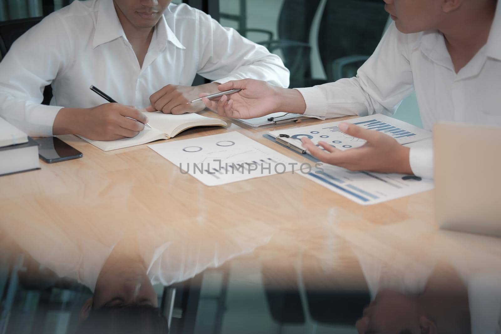 financial adviser analyzing performance revenue with investor. business people discussing in meeting. businessman working with co-worker team.