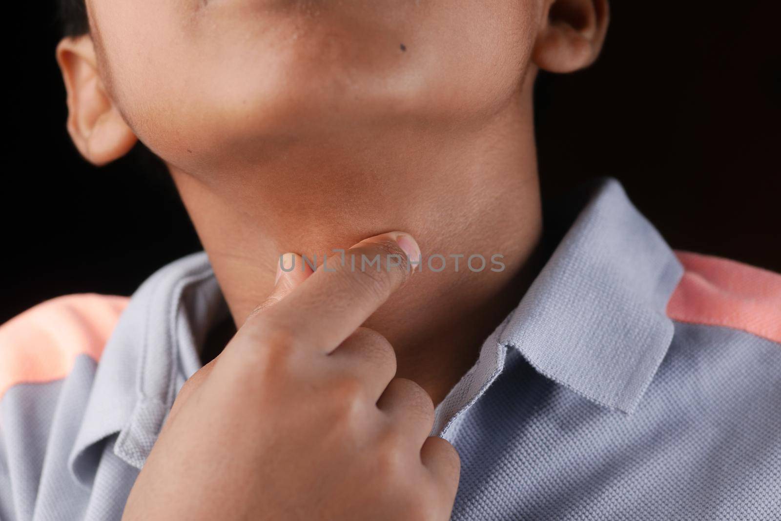 teenage boy suffering throat pain close up .