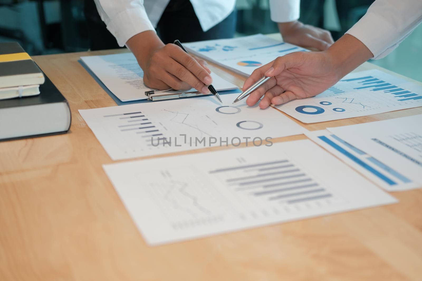 financial adviser analyzing performance revenue with investor. business people discussing in meeting. businessman working with co-worker team.