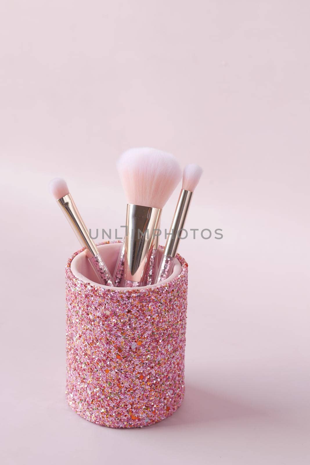 beauty brush in a box on light purple background .