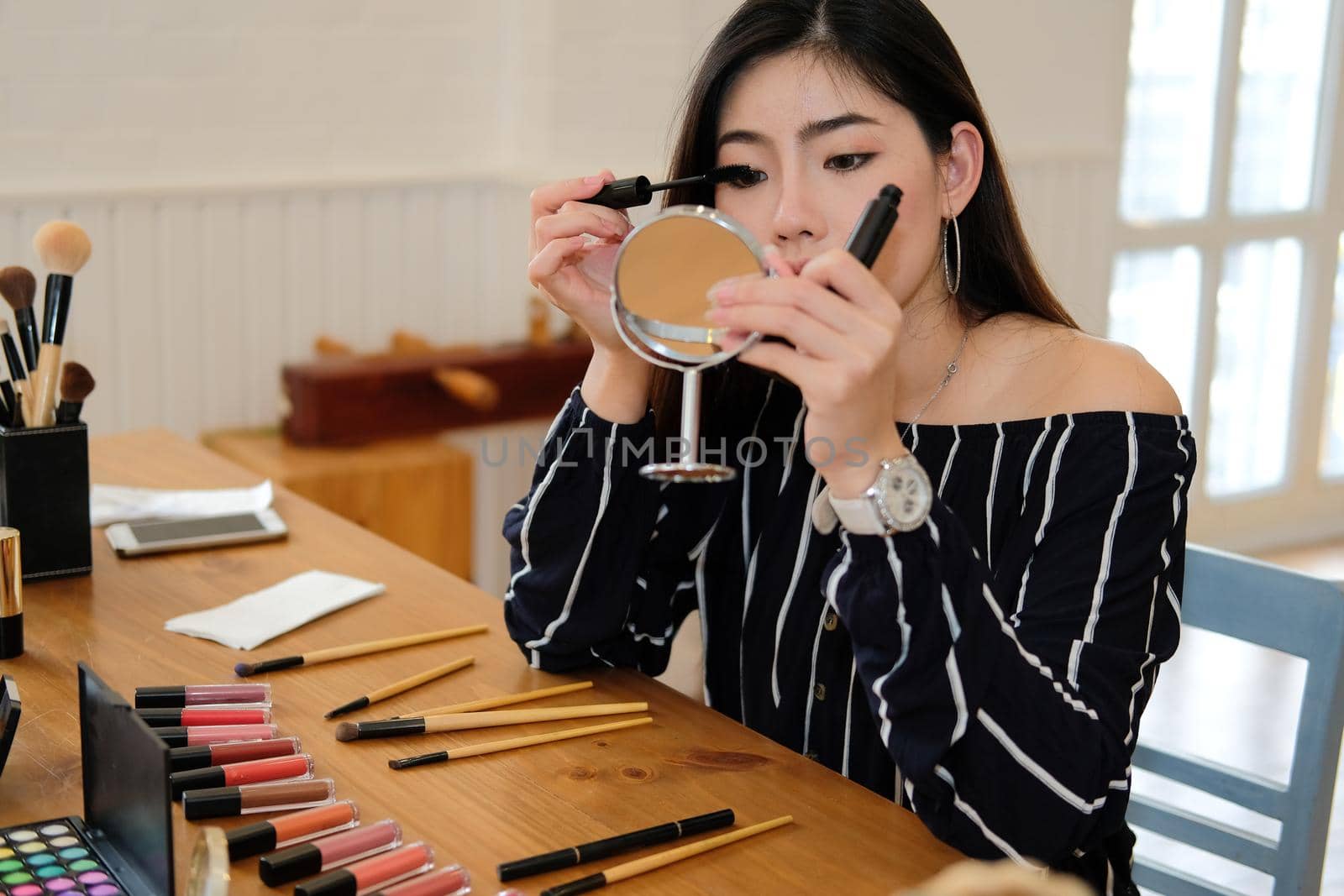 asian woman applying makeup cosmetic. make up beauty concept