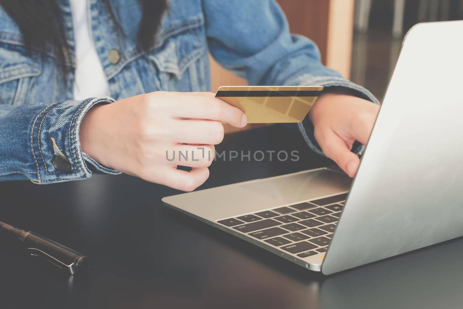 woman holding credit card using computer for shopping online