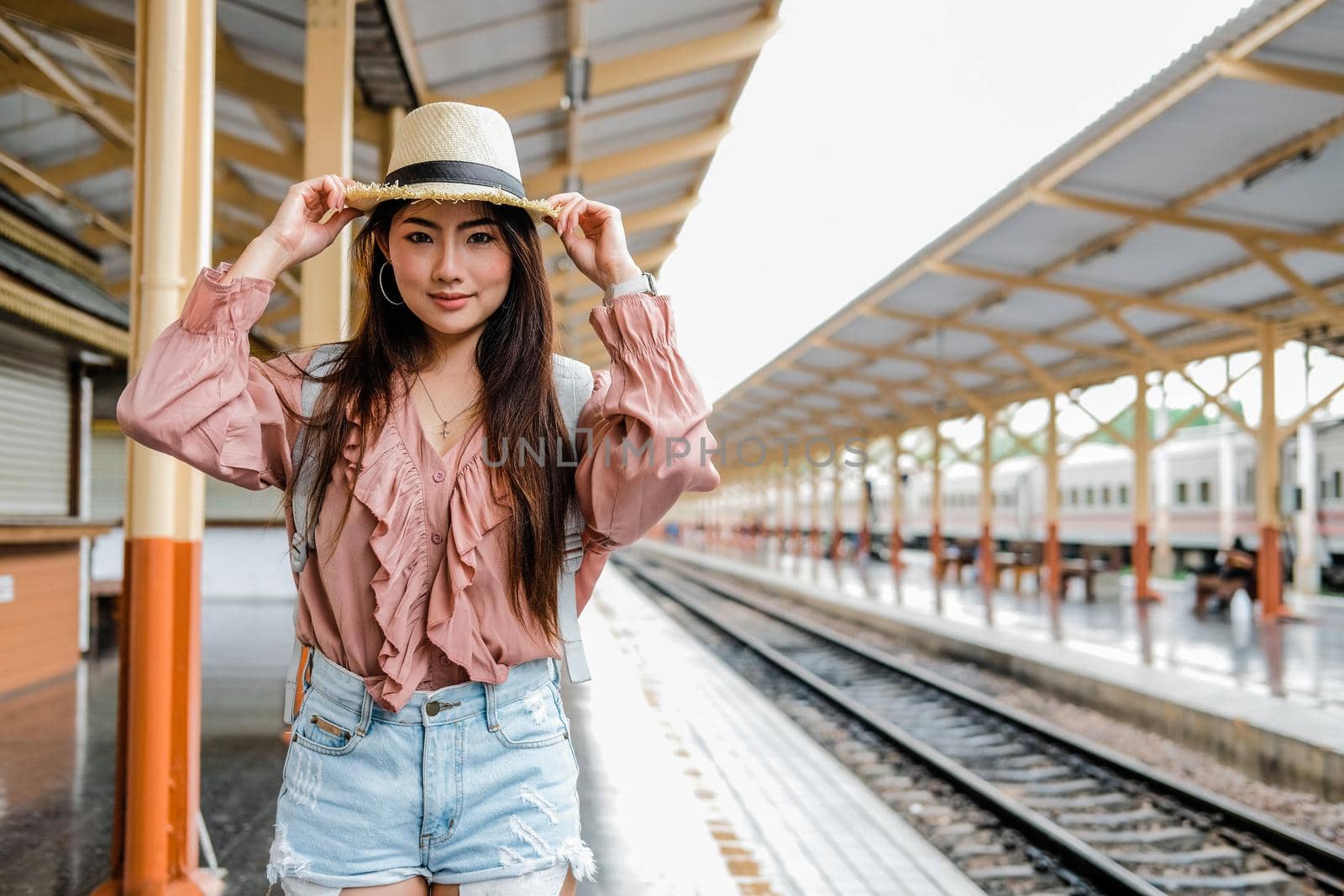 woman backpacker traveler with backpack at train station. journey trip travel concept by pp99