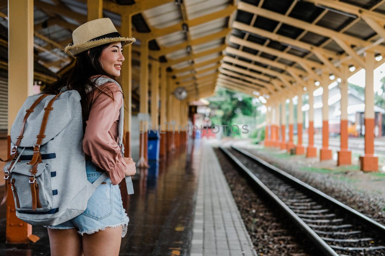 woman  backpacker traveler with backpack at train station. journey trip travel concept by pp99