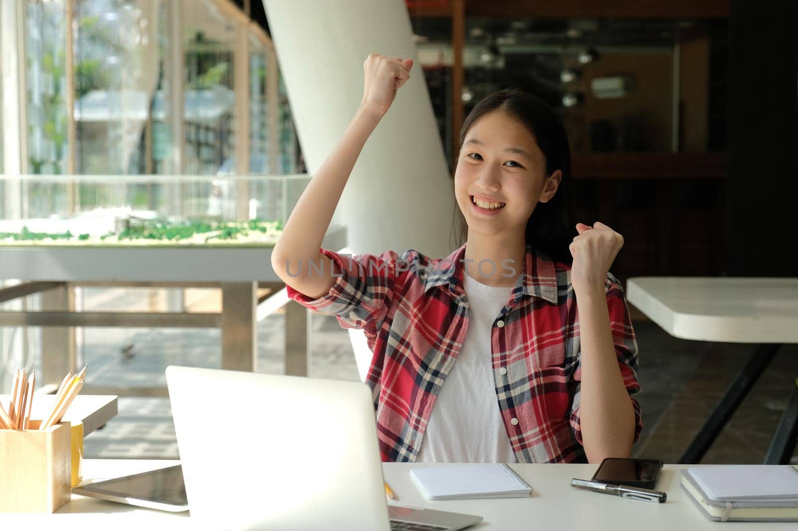 happy asian woman girl teenager raising hands with gladness happiness