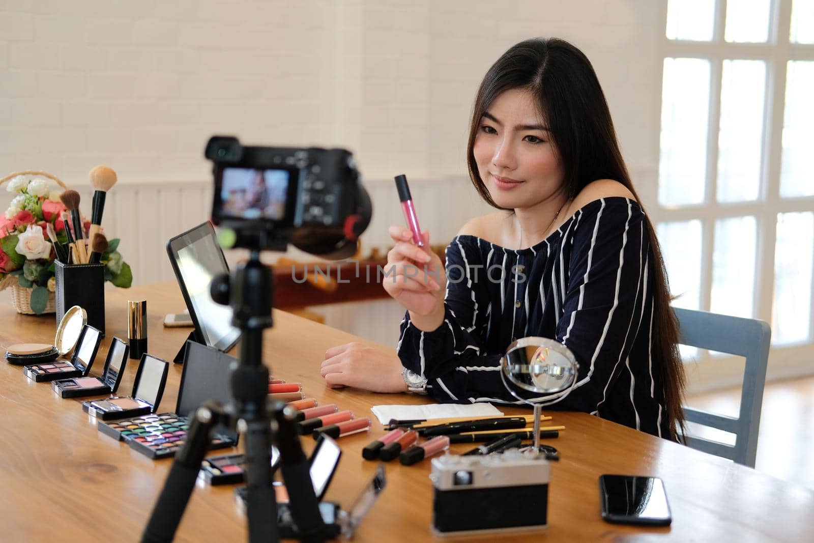 beauty blogger live broadcasting cosmetic makeup tutorial on social media. vlogger recording vlog video. influencer marketing