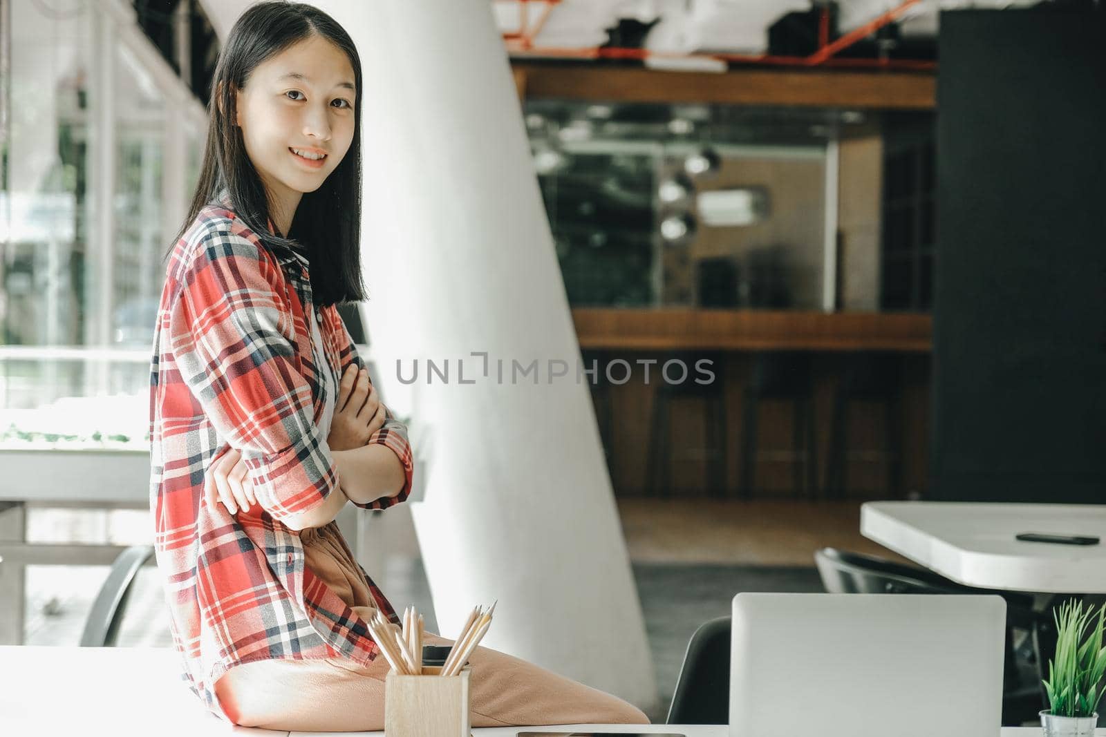 asian teenage girl teenager posing at co-working space