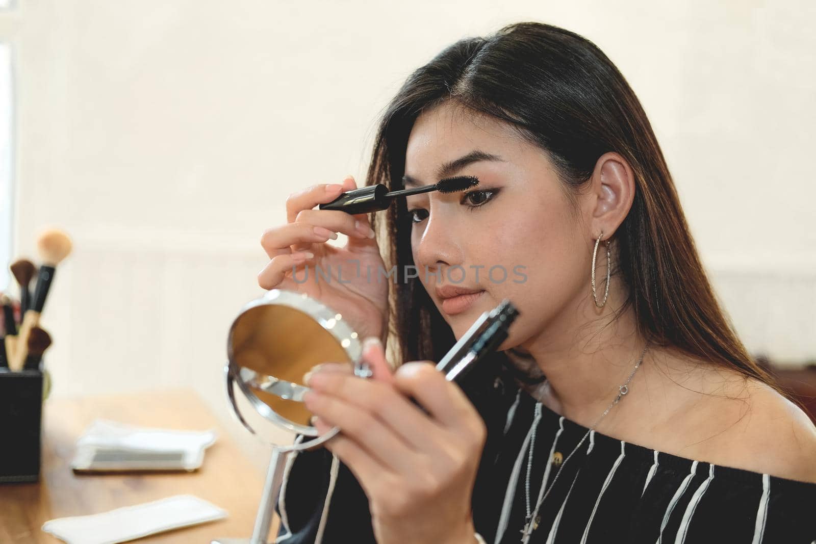 asian woman applying makeup cosmetic. make up beauty concept