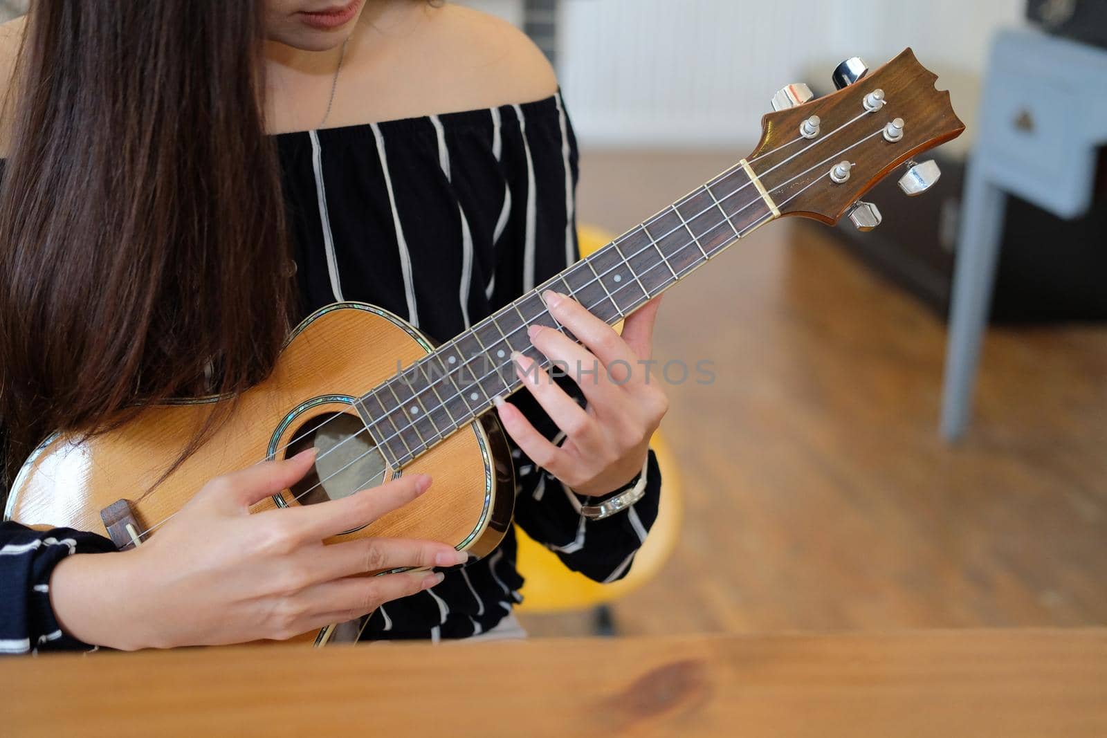 woman playing guitar at home.  leisure lifestyle concept