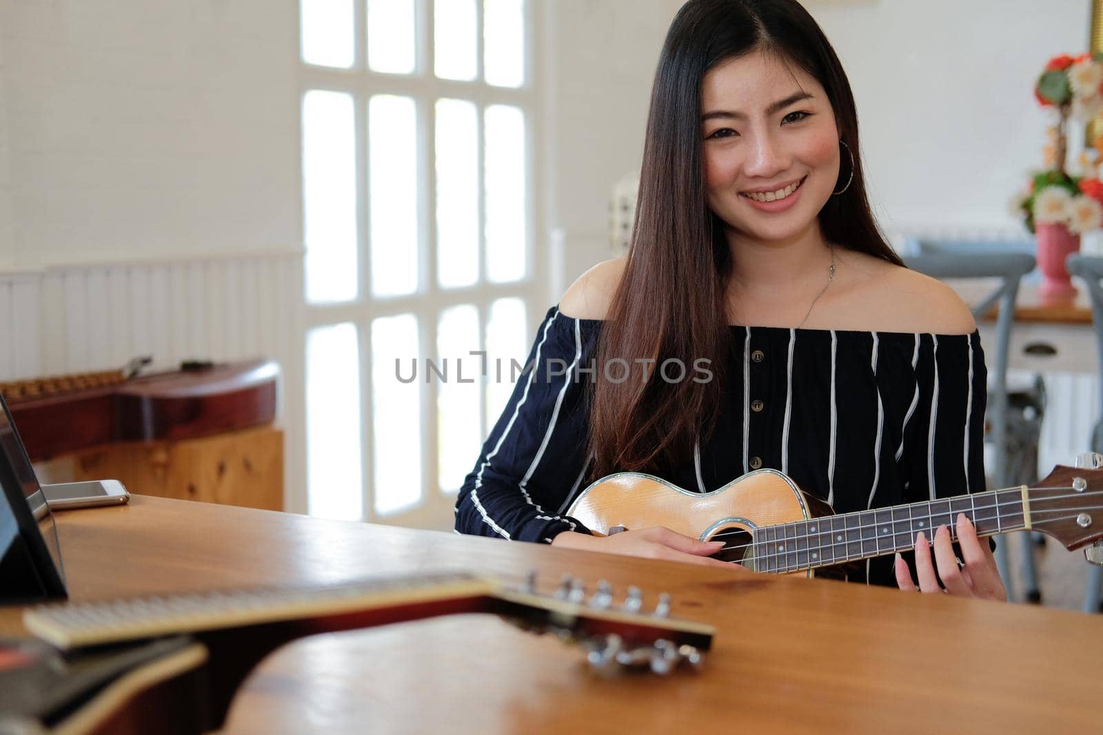 woman playing guitar at home.  leisure lifestyle concept