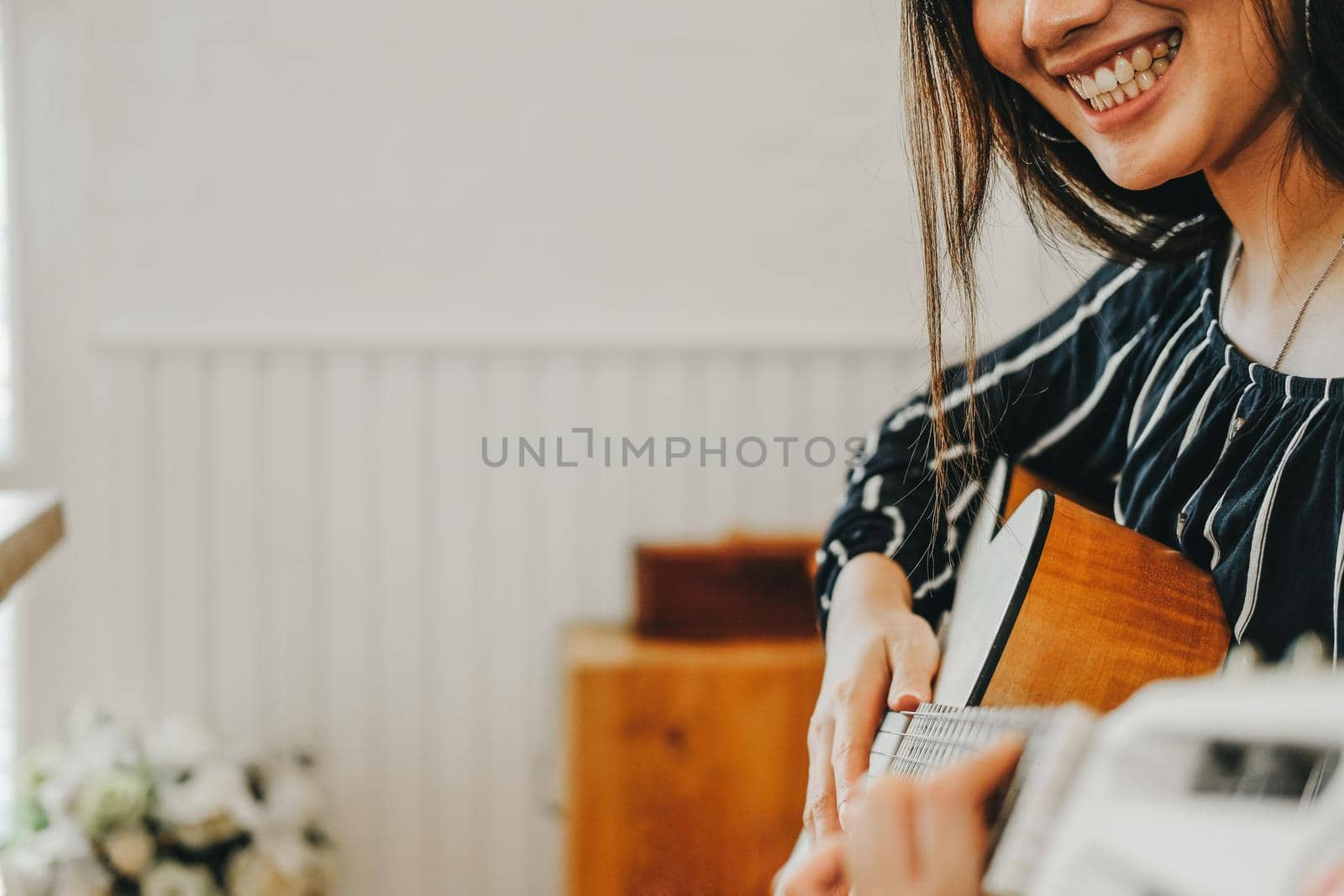 woman playing guitar at home.  leisure lifestyle concept