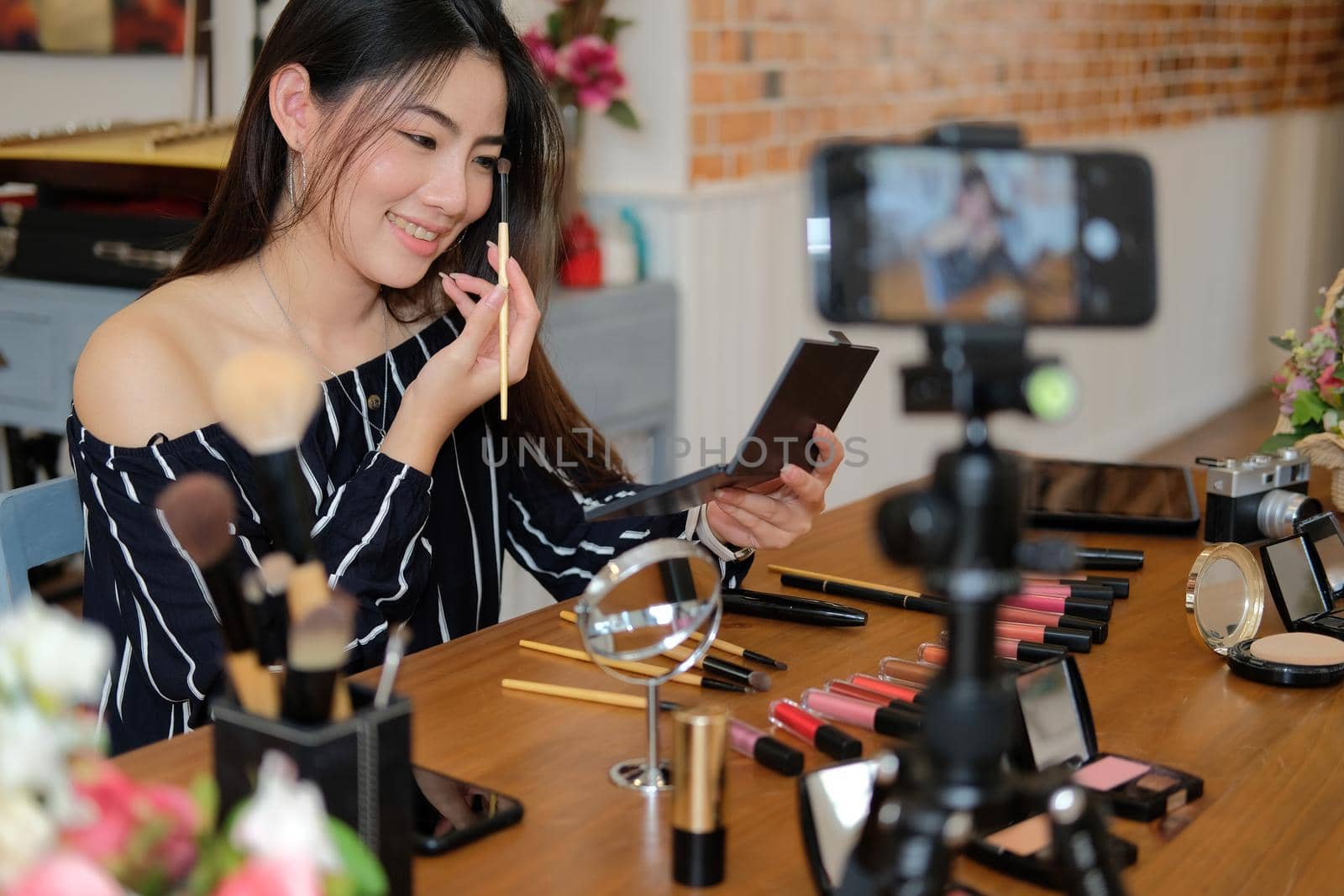 beauty blogger live broadcasting cosmetic makeup tutorial on social media. by pp99