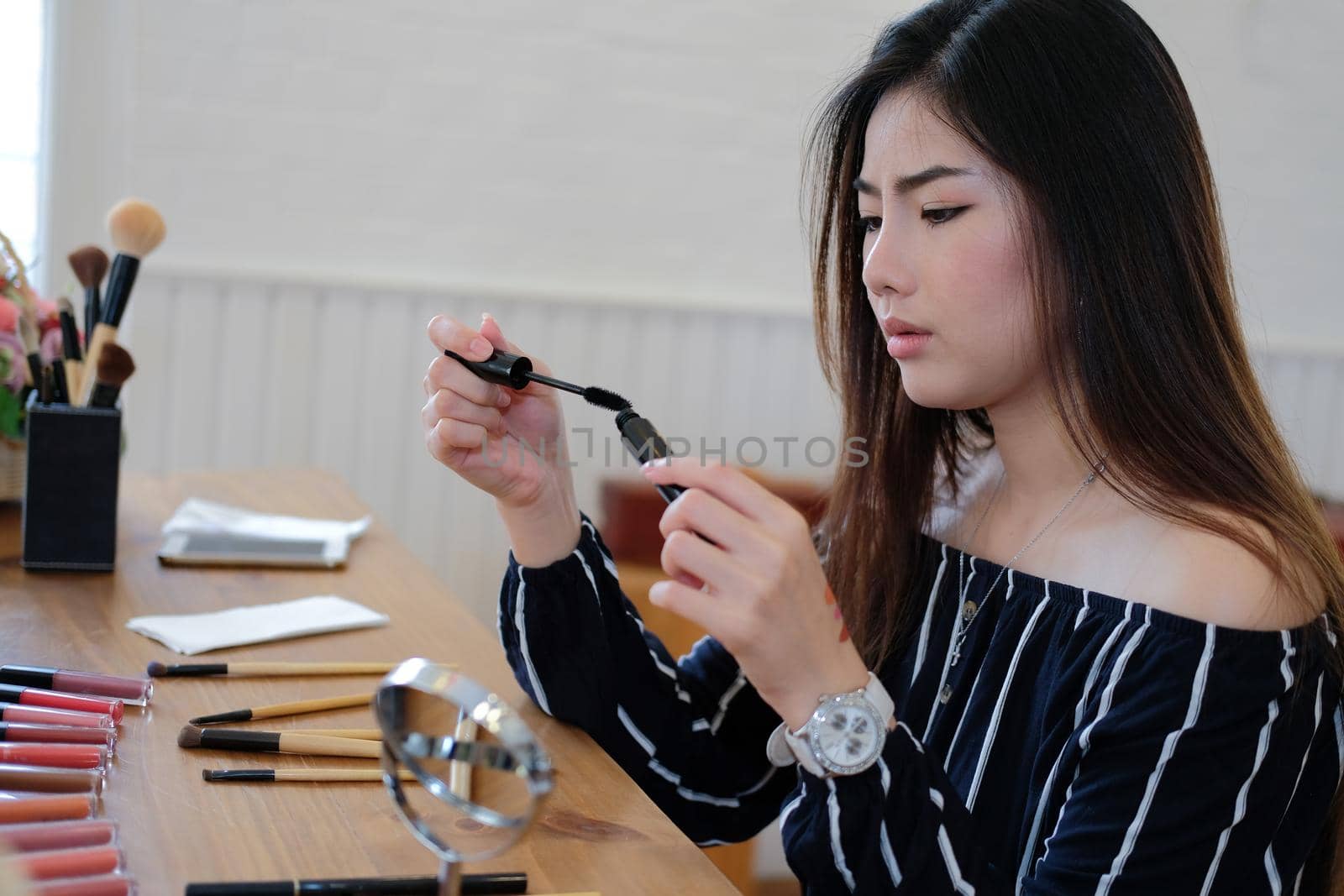 asian woman applying makeup cosmetic. make up beauty concept