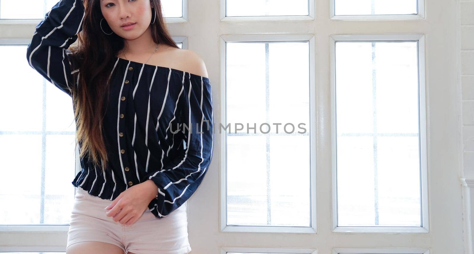 young asian woman in casual clothing posing at home