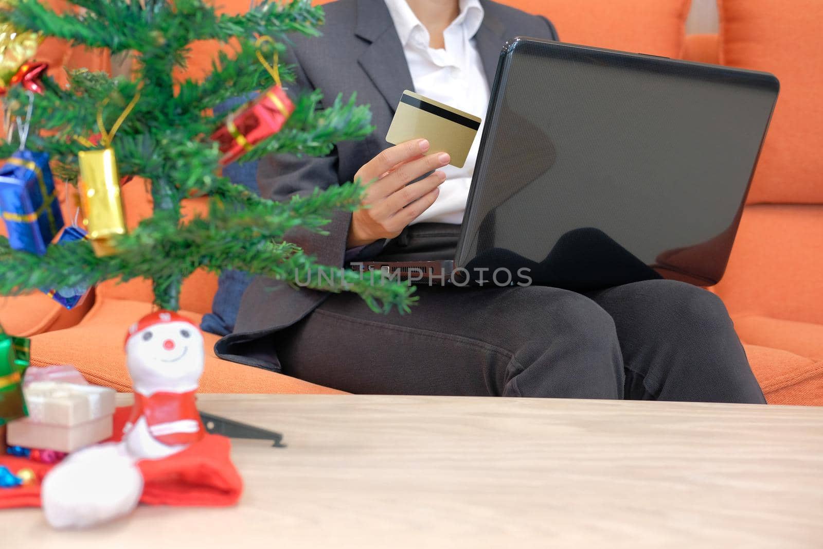 man holding credit card & computer for online shopping.  businesswoman buying christmas gift on internet. new year holiday merry xmas celebration
