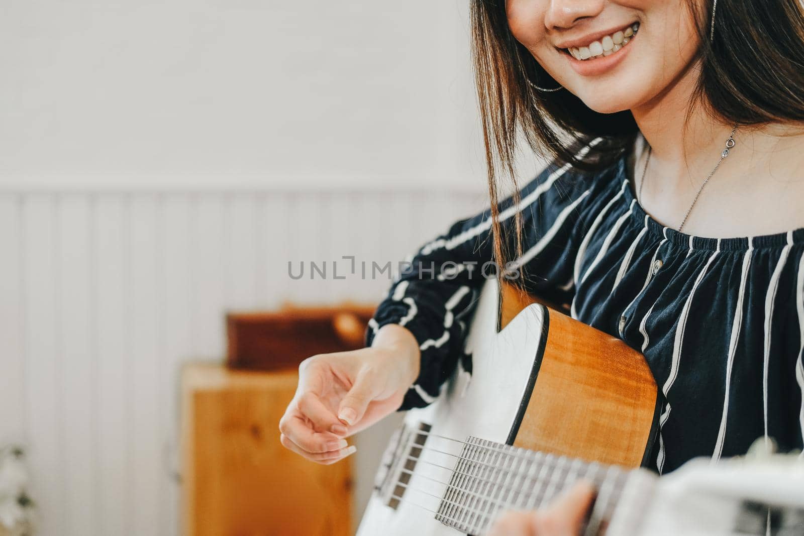 woman playing guitar at home.  leisure lifestyle concept