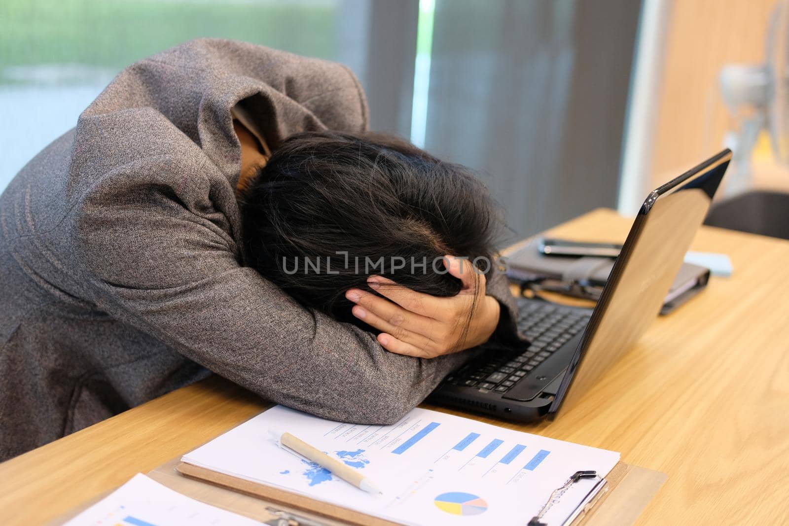 woman put hand on head feeling tired, frustrated & stressed from hard work at office. exhausted businesswoman have headache at workplace.