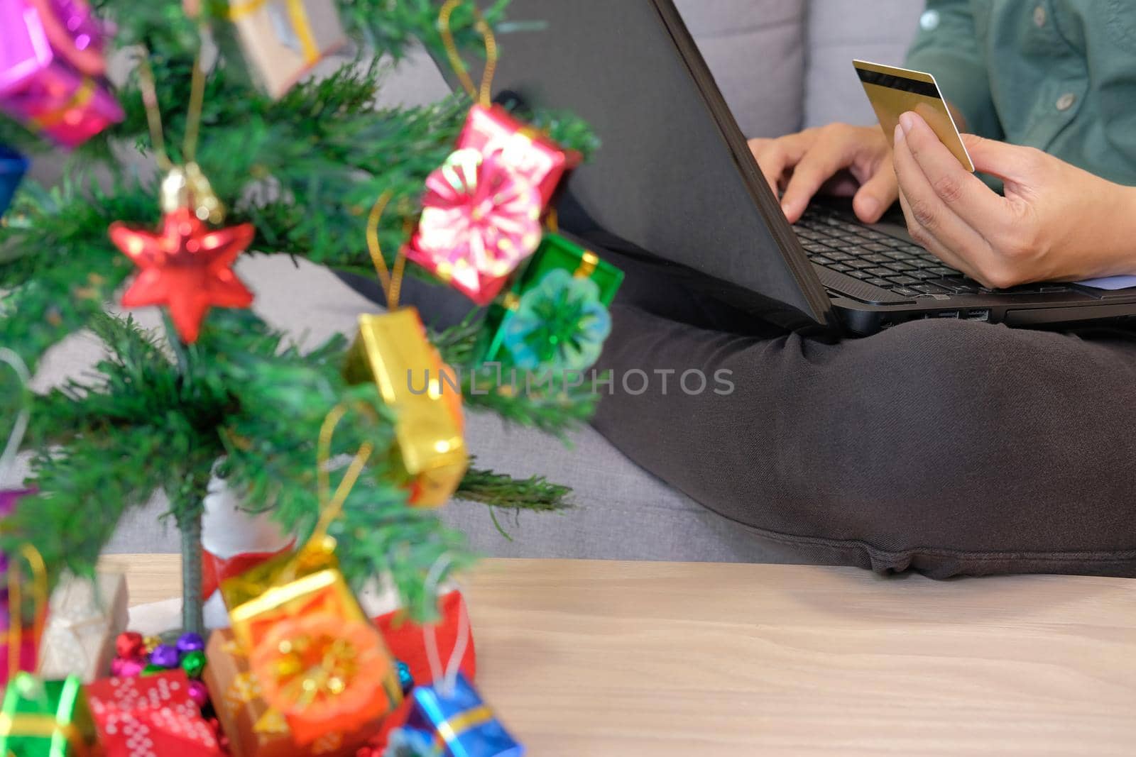 man holding credit card for online shopping. male buyer buying christmas gift on internet. new year holiday merry xmas celebration