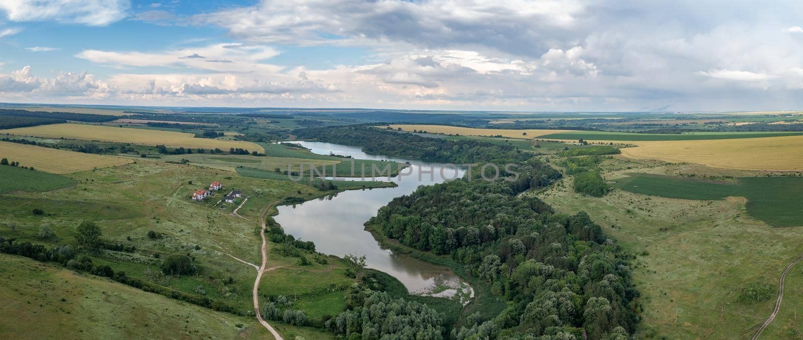 Panoramic aerial view from the drone of beautiful countryside with lake like a snake