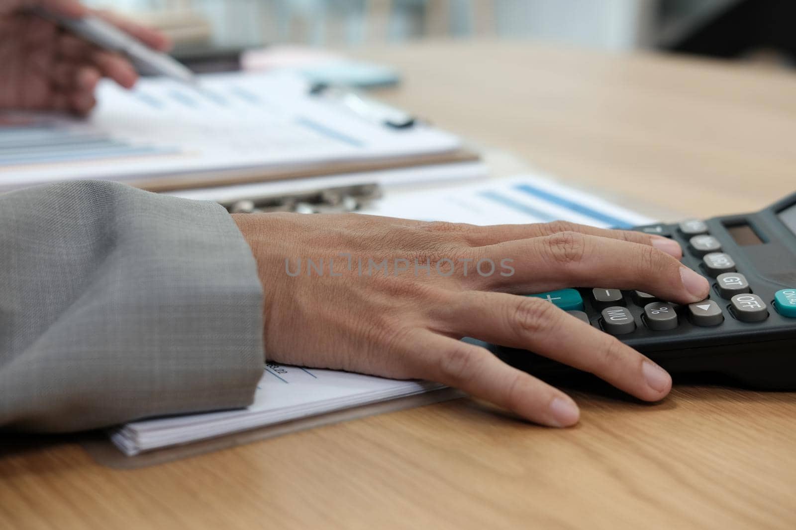 financial adviser working with calculator, business document at office. accountant doing accounting & calculating revenue & budget. bookkeeper making calculation. finance & economy concept