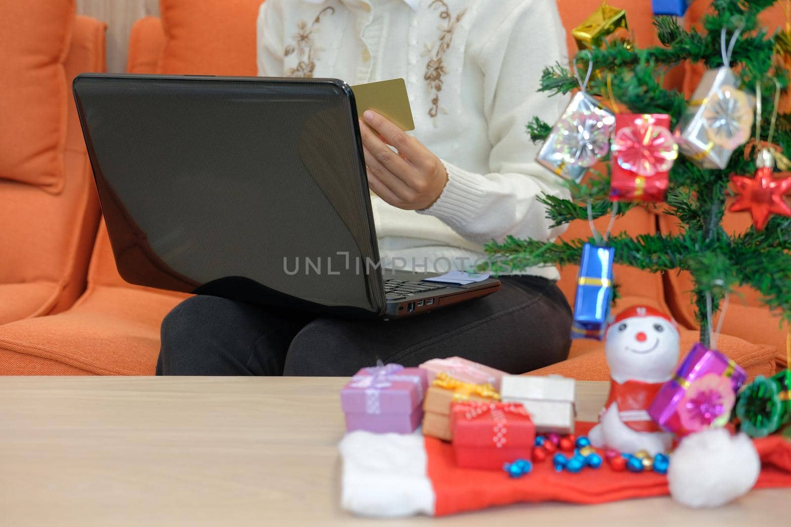 woman holding credit card for online shopping.  female buyer buying christmas gift on internet. new year holiday merry xmas celebration