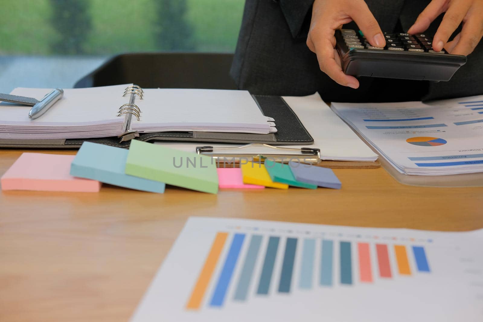 financial adviser working with calculator at office. accountant doing accounting & calculating revenue & budget. bookkeeper making calculation. finance & economy concept