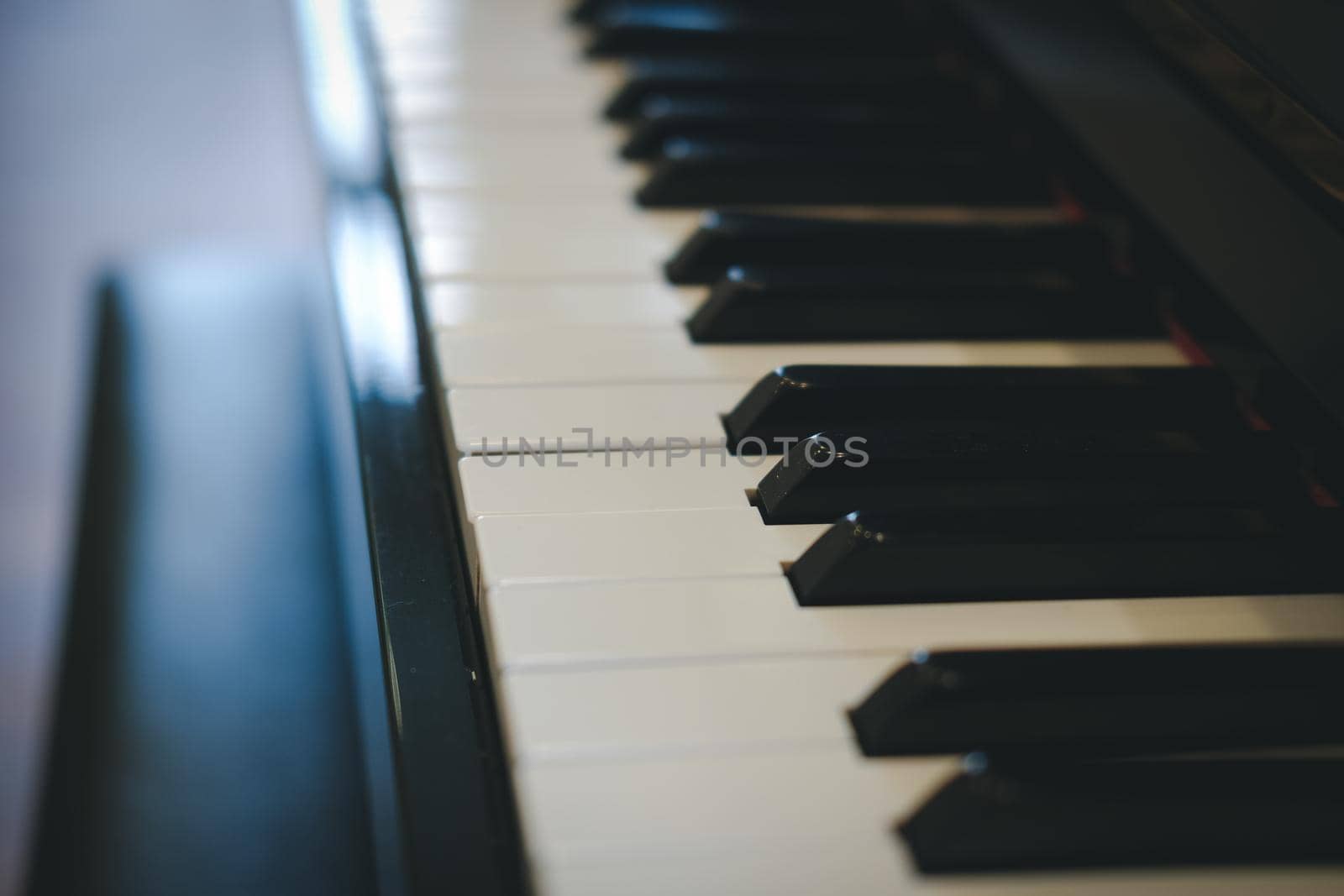 piano keyboard with glossy black & white keys. classic music instrument