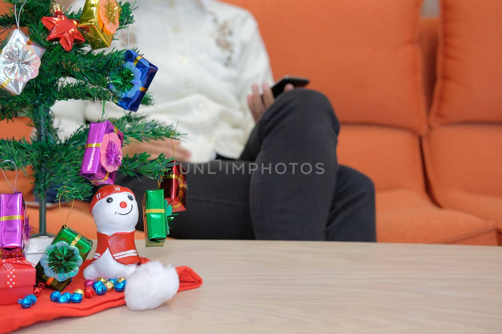 woman using smartphone at home. girl texting message on mobile phone during xmas. christmas holiday new year celebration season greetings