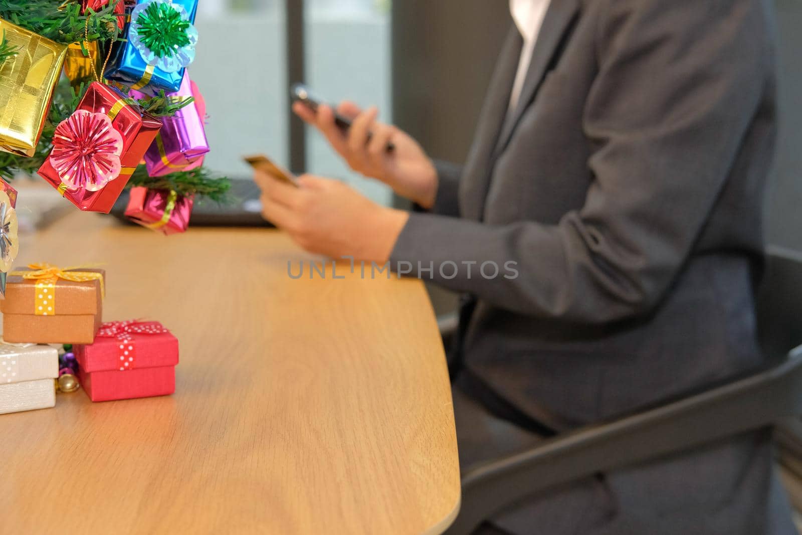 woman holding credit card using smart phone for online shopping. businesswoman buying on internet, make payment on website during christmas new year holiday