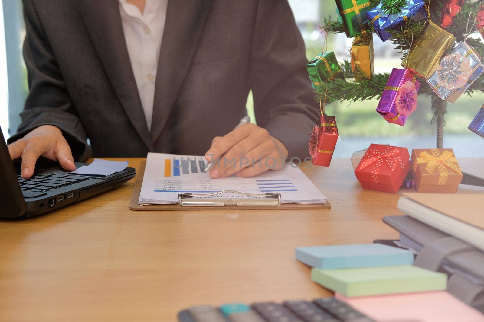 businessman using computer. startup man working with document at office. young male entrepreneur analyze financial data at workplace during christmas new year holiday