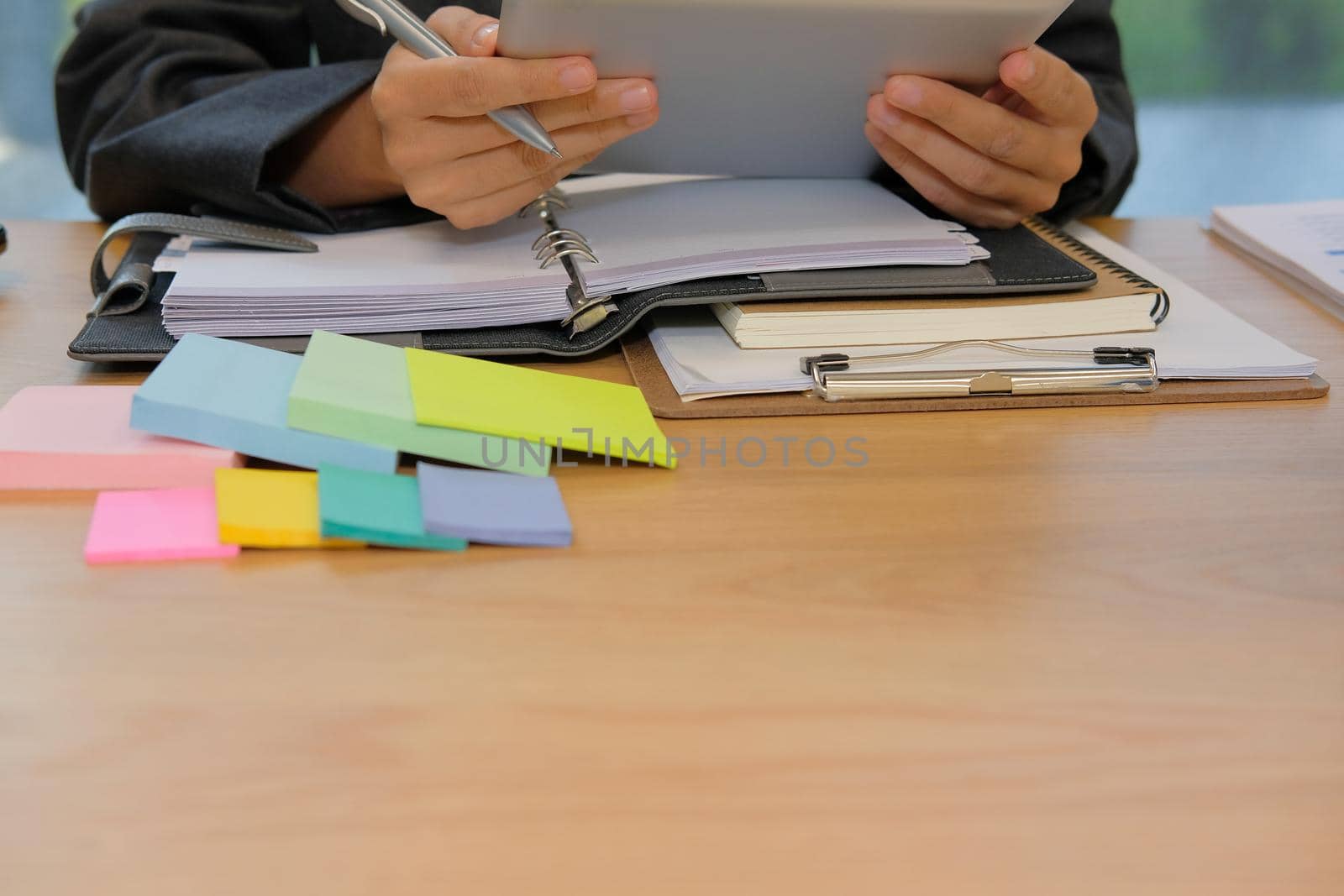 man organizing plan with tablet. businessman working  at workplace coworking office