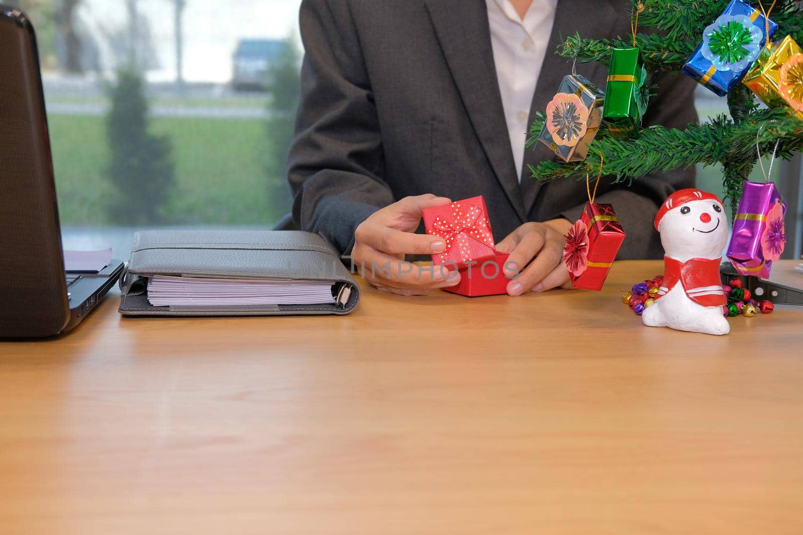 businesman opening christmas new year gift box at office workplace