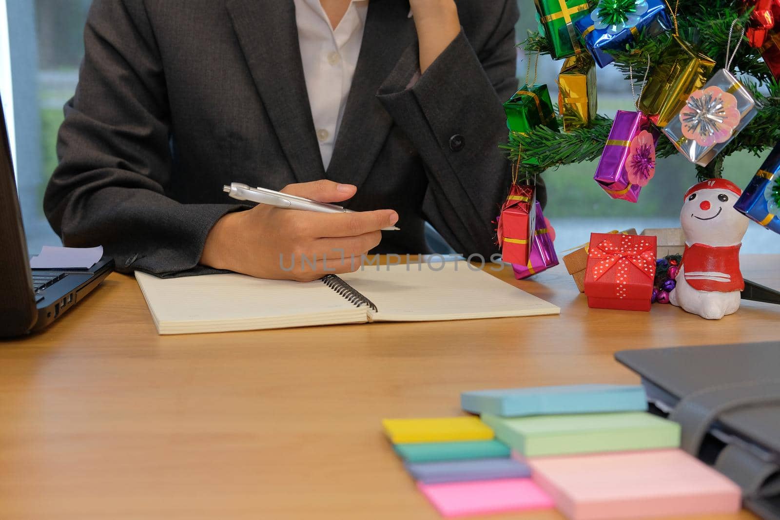 man organize plan with notebook. businessman working at workplace during christmas new year holiday by pp99