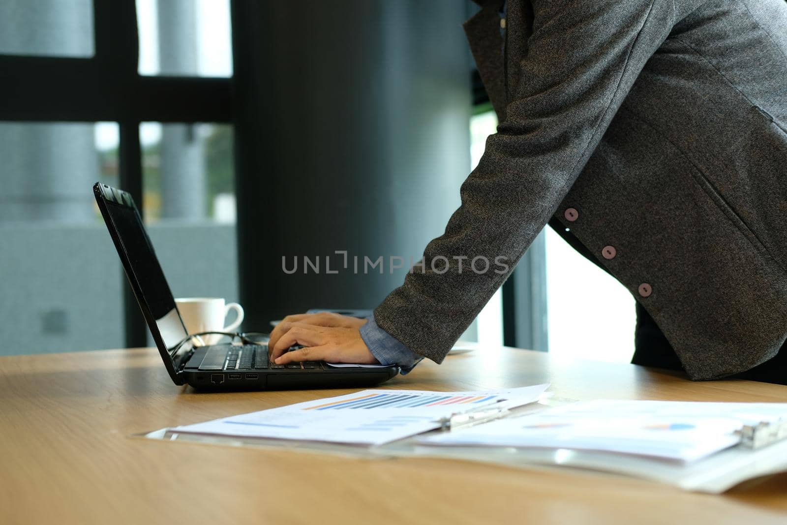 man typing on computer laptop keyboard working at office by pp99