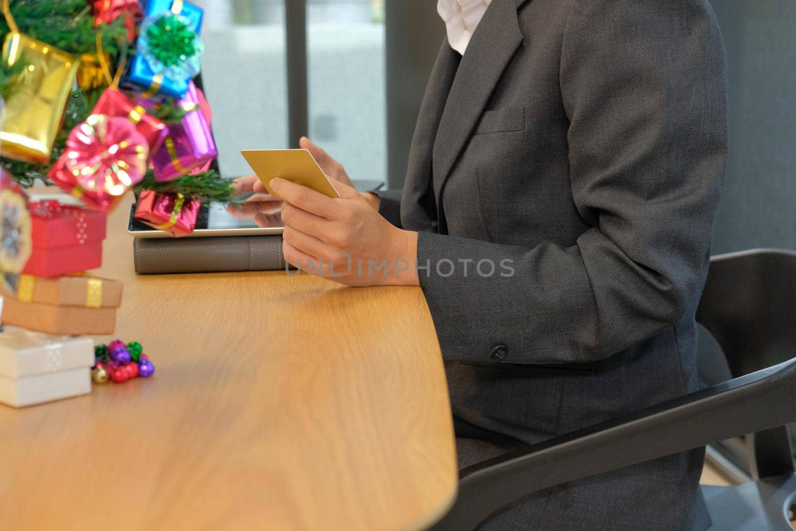 woman holding credit card using tablet for online shopping. businesswoman buying on internet, make payment on website during christmas new year holiday