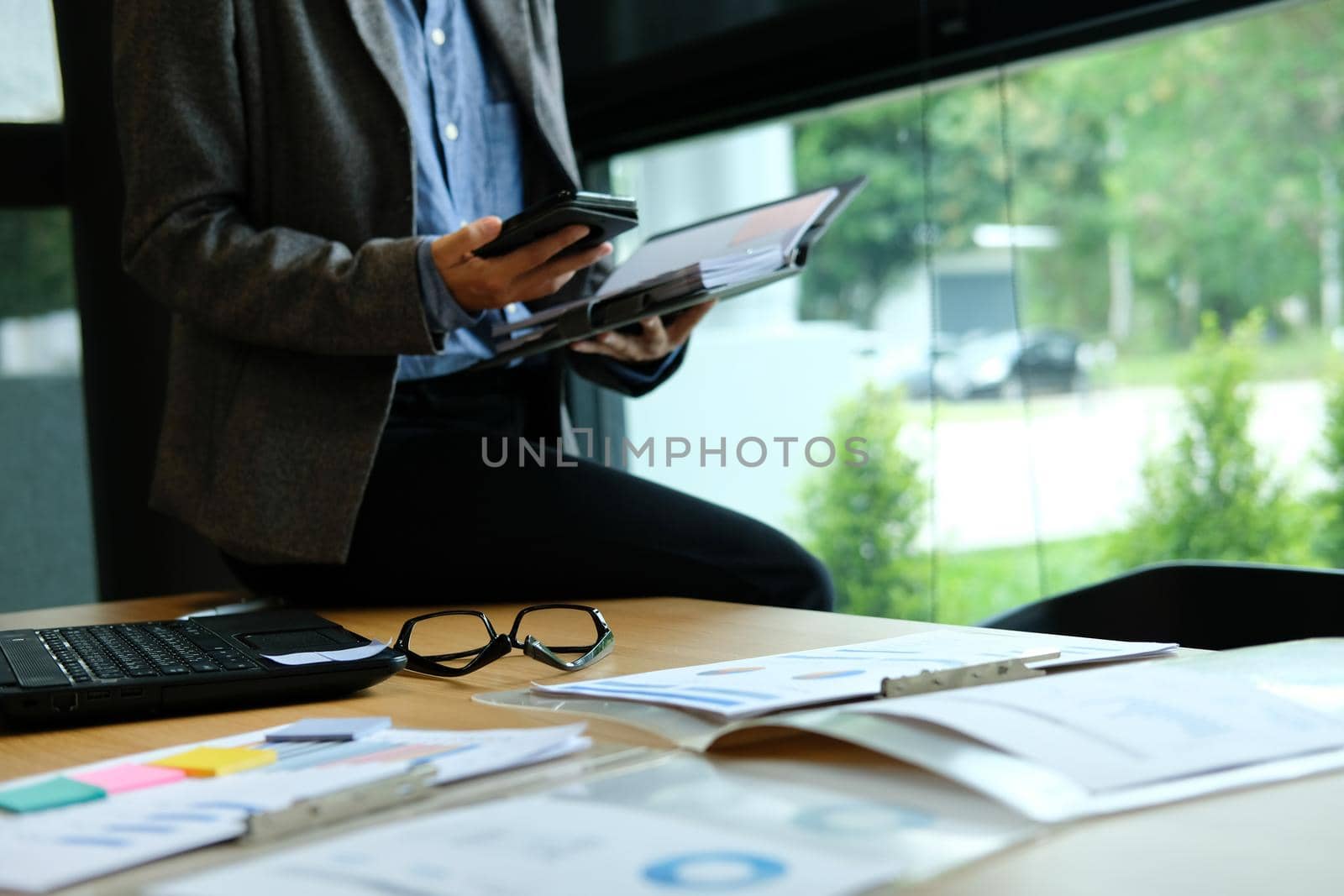 man organizing plan with notebook & smart phone. businessman working  at workplace coworking office