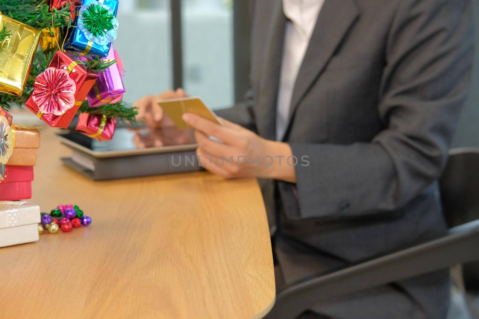 woman holding credit card using tablet for online shopping. businesswoman buying on internet, make payment on website during christmas new year holiday