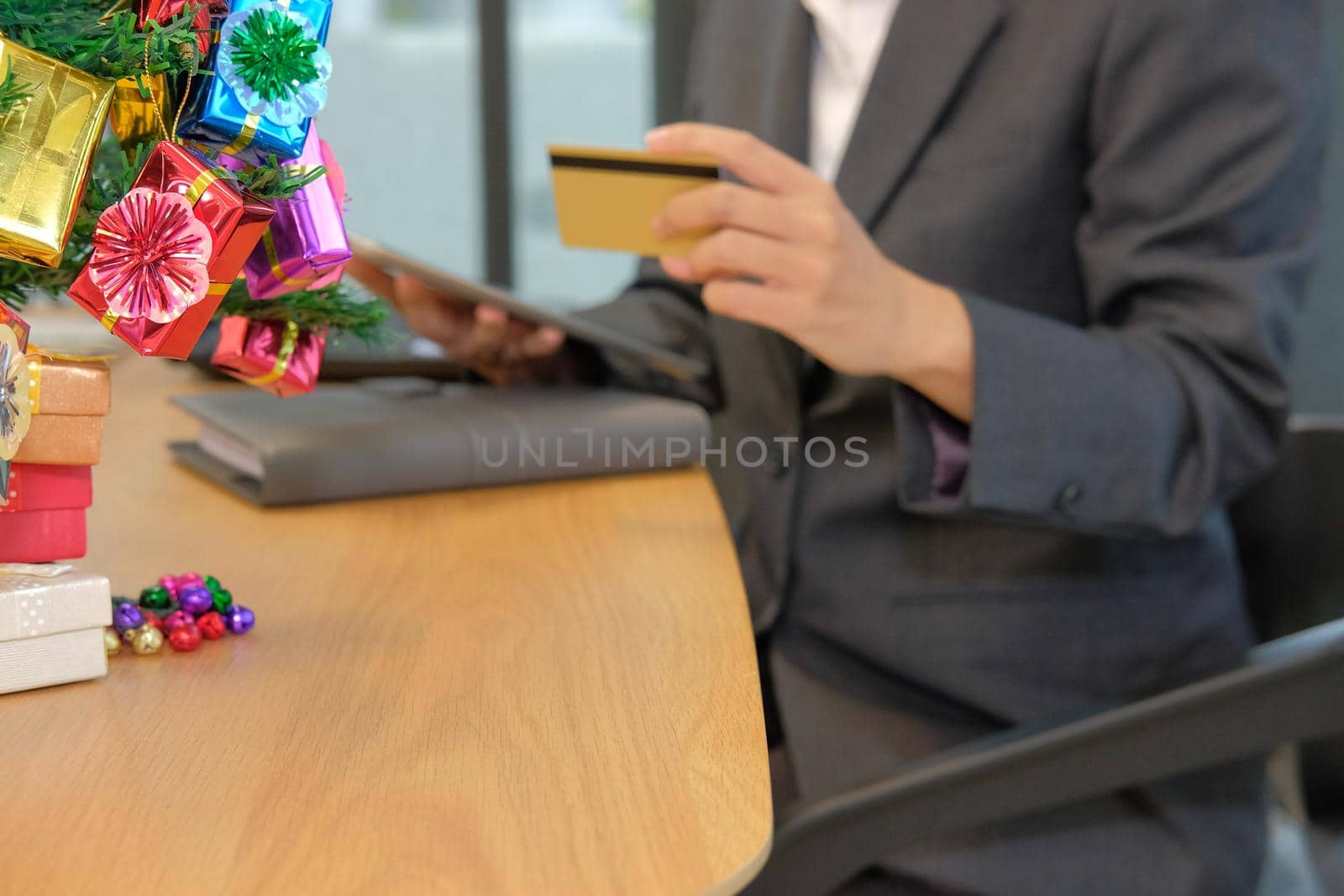 woman holding credit card using tablet for online shopping. businesswoman buying on internet during christmas holiday by pp99