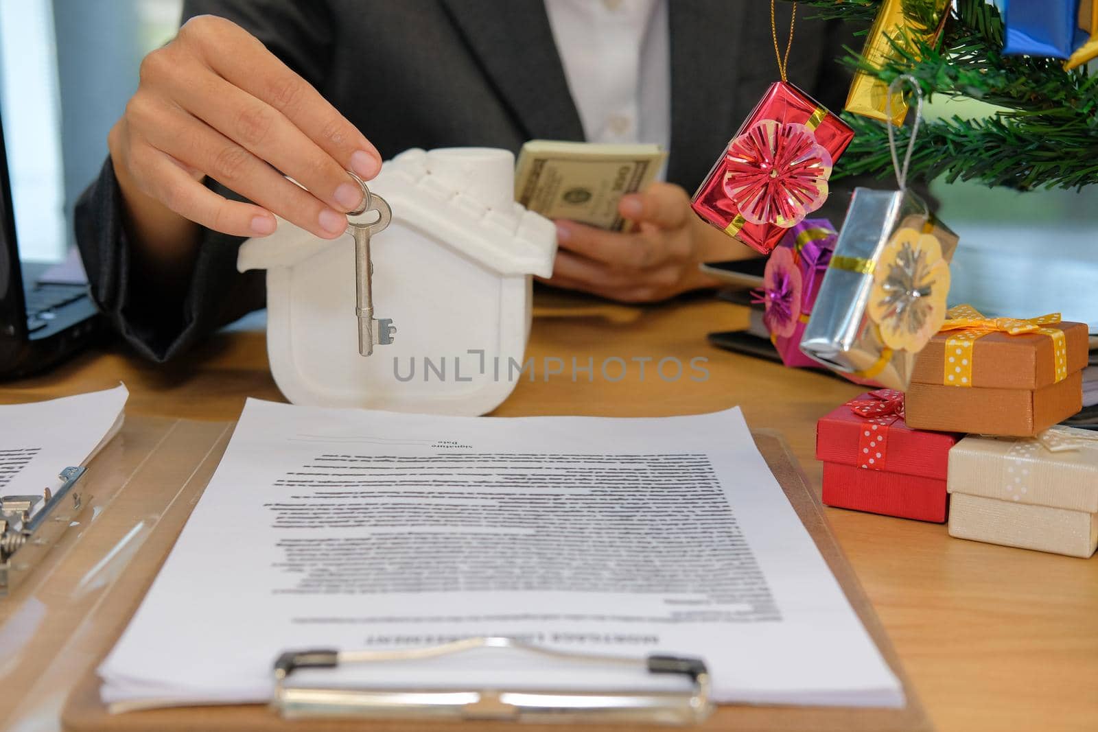 realtor agent with house model banknote & key. buying selling renting real estate property