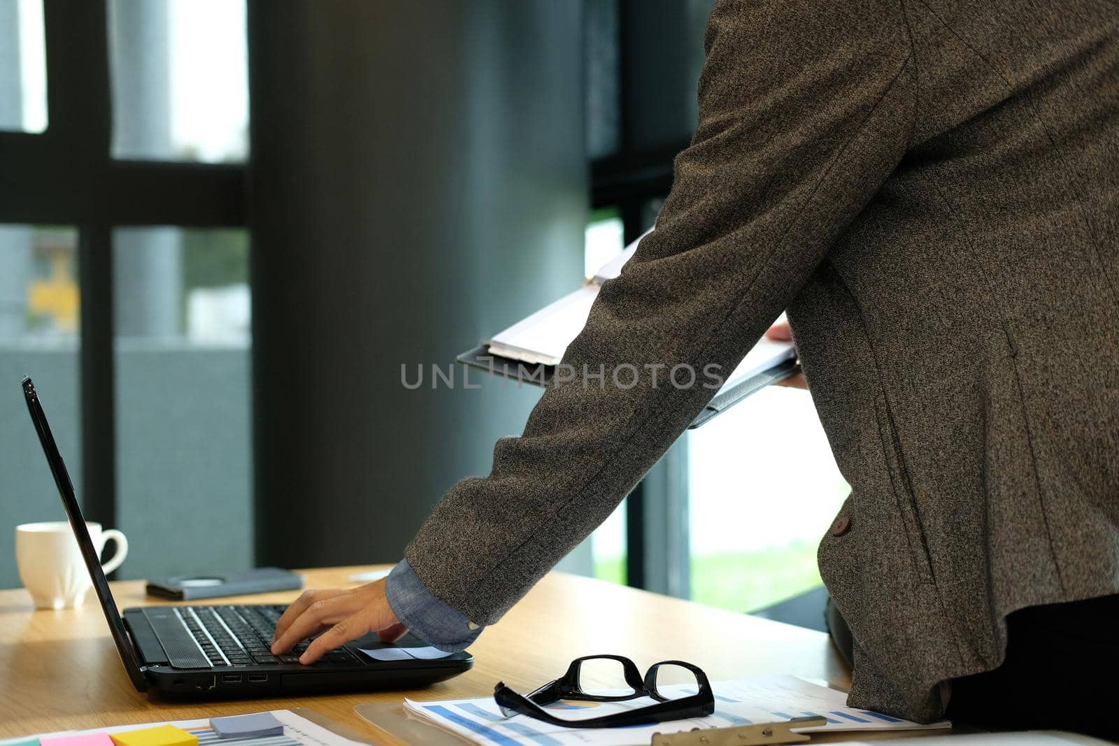 man working with computer. businessman organizing plan with notebook at workplace coworking office