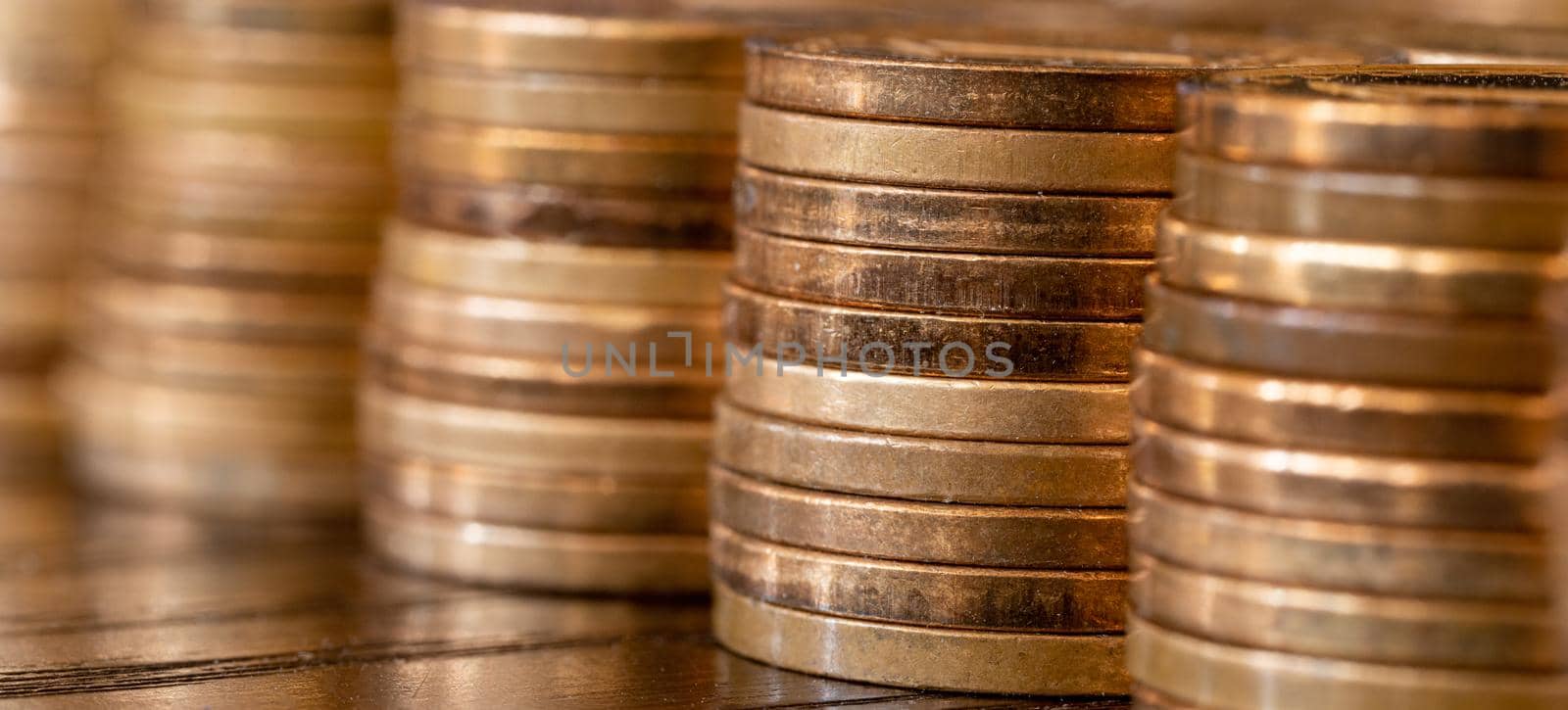 Banner with piles of coins on the table. Coins side view. Coins macro shot.