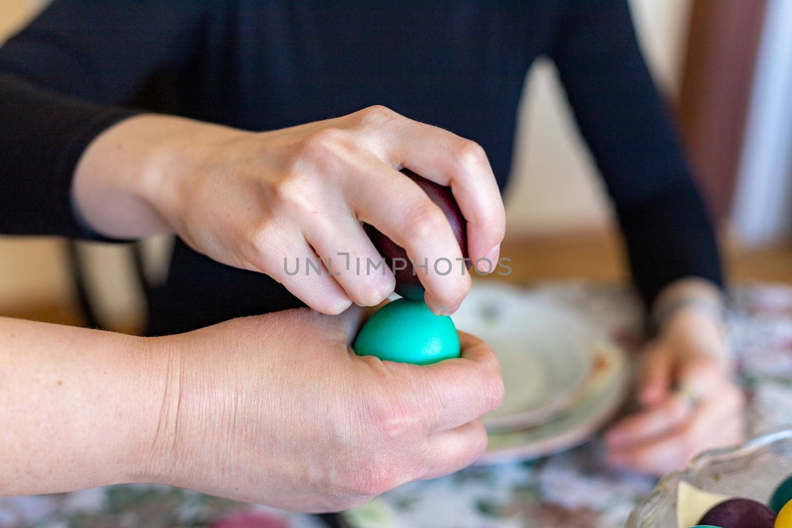 Hands Knocking Easter Eggs.  Fight game seasonal tradition.