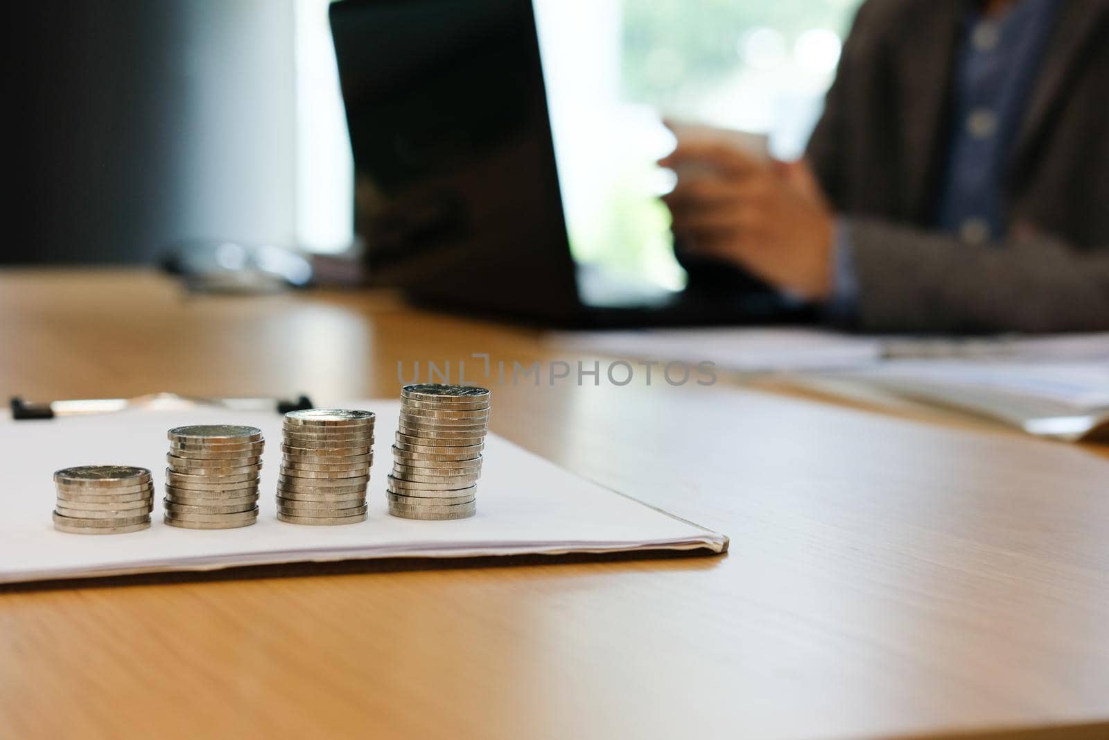 businessman with coffee cup working at workplace. coins stack & business growth by pp99