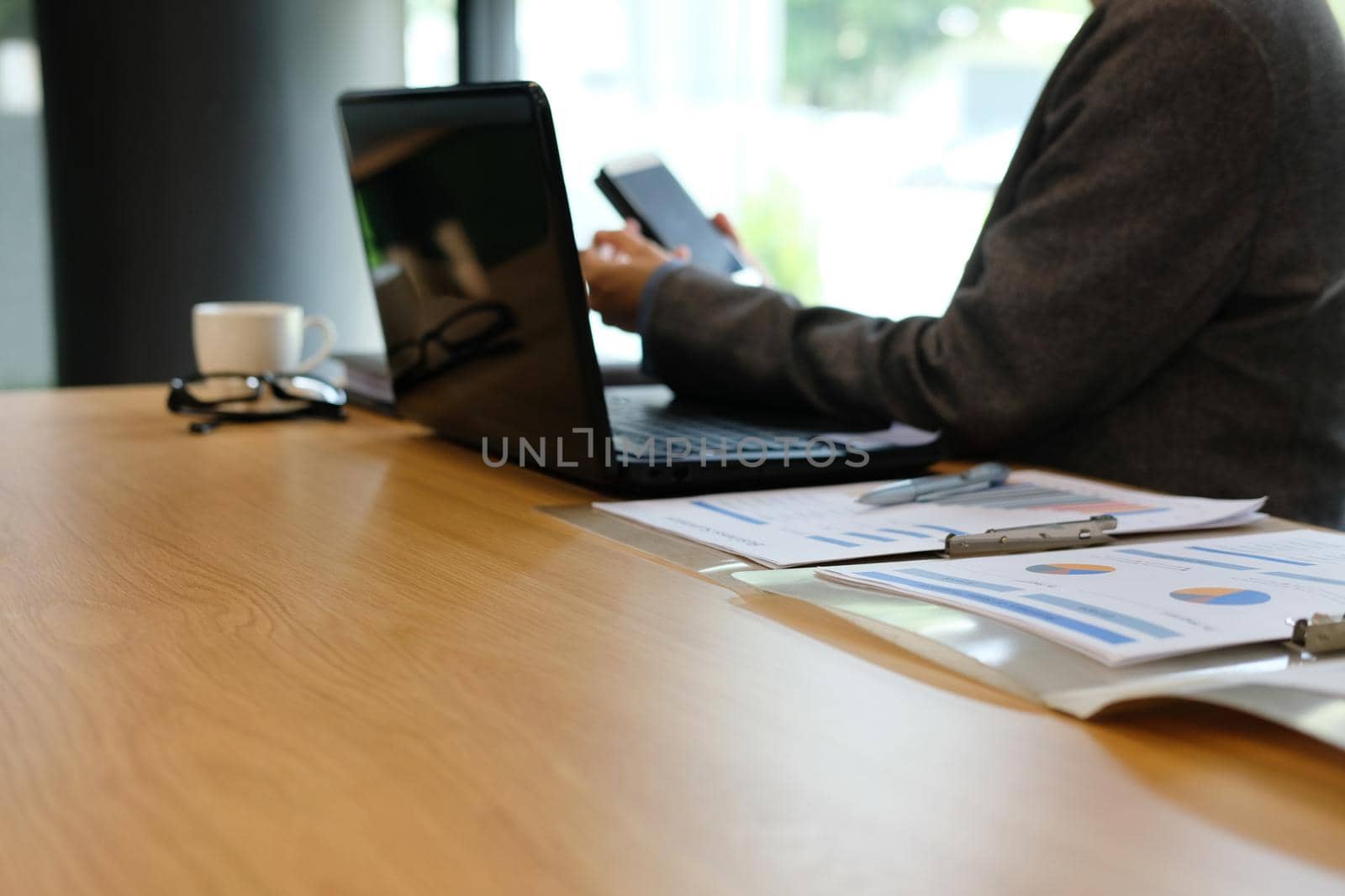 businessman using smart phone at workplace. startup man working at office. by pp99