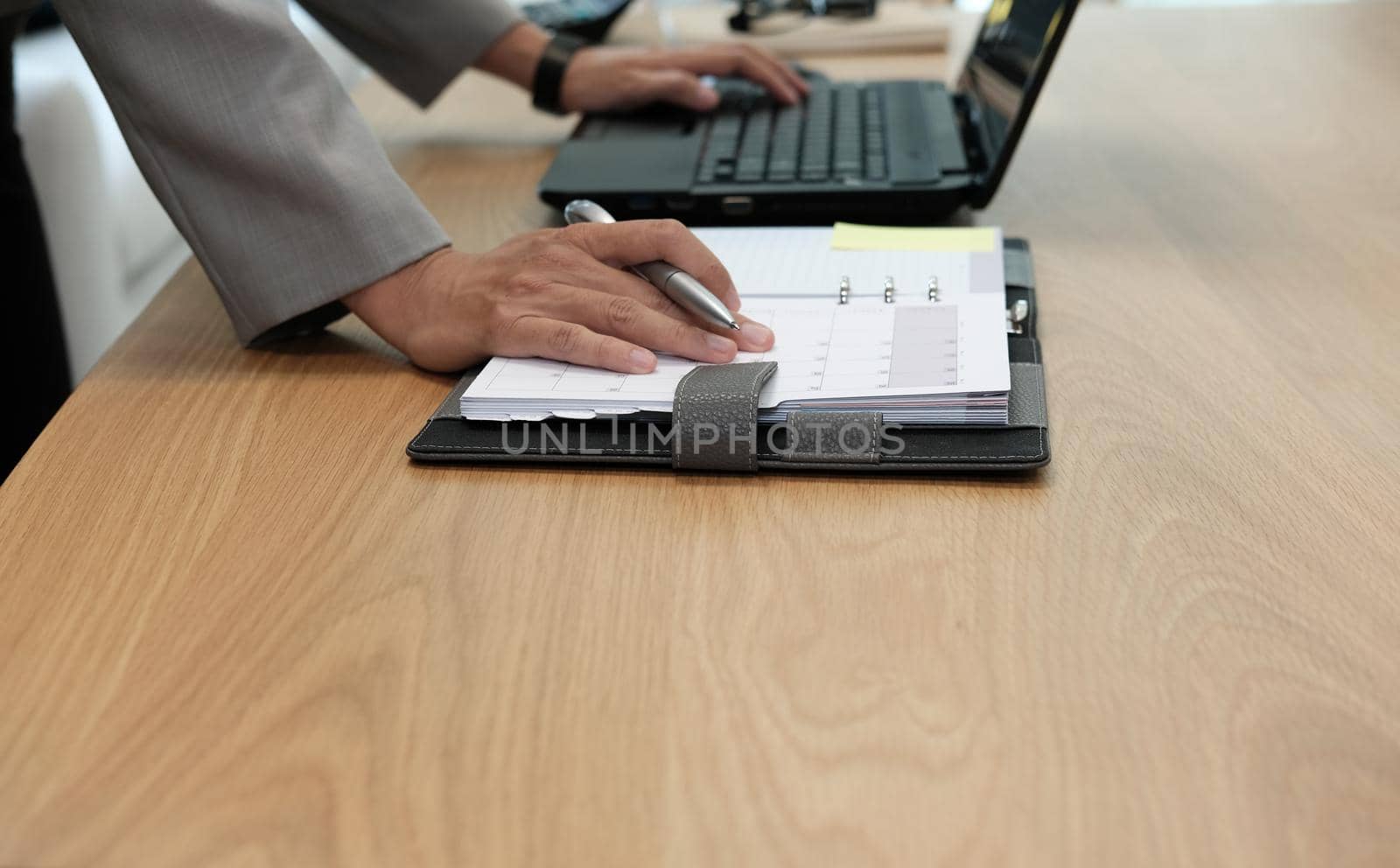 man organize plan with notebook & computer. businessman working at workplace coworking office