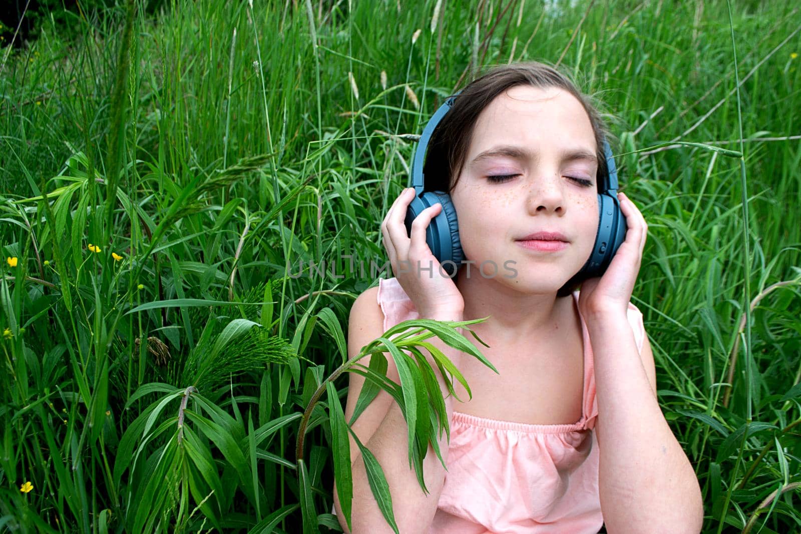 young girl listening to music on headphones. top view. The concept of lifestyle. High quality photo
