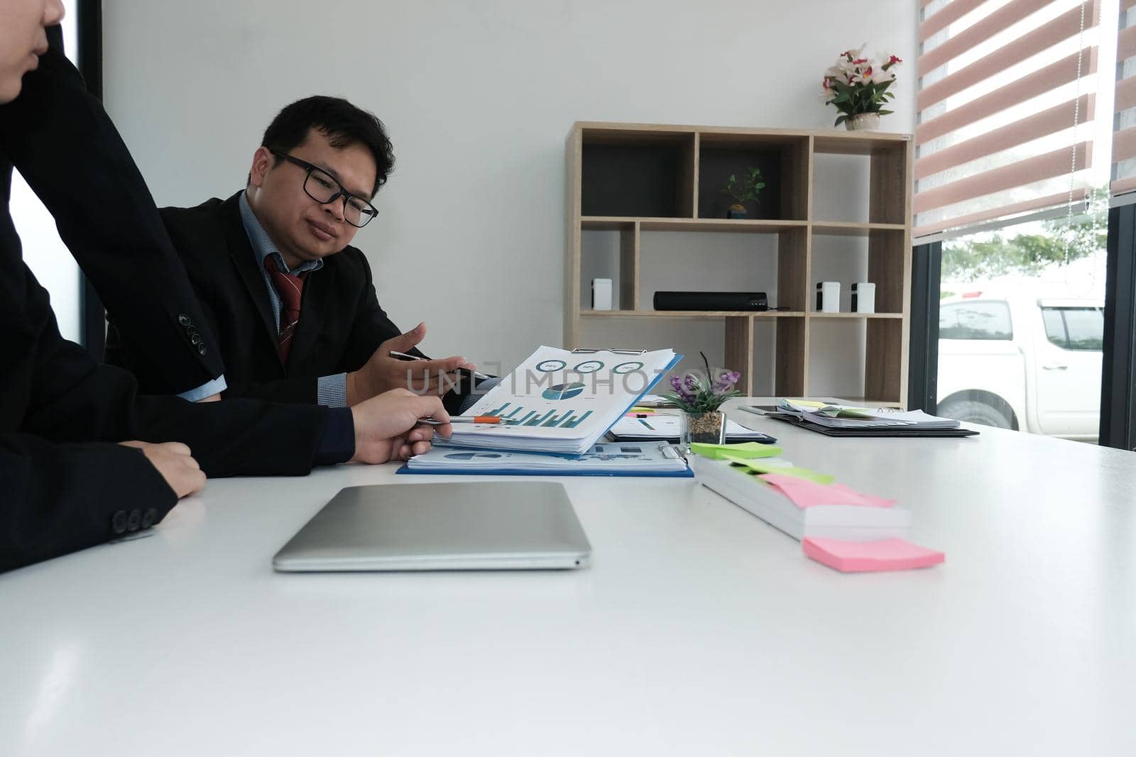 business adviser analyzing company financial report. professional investor discussing idea. businessman working on new startup project with co working team.